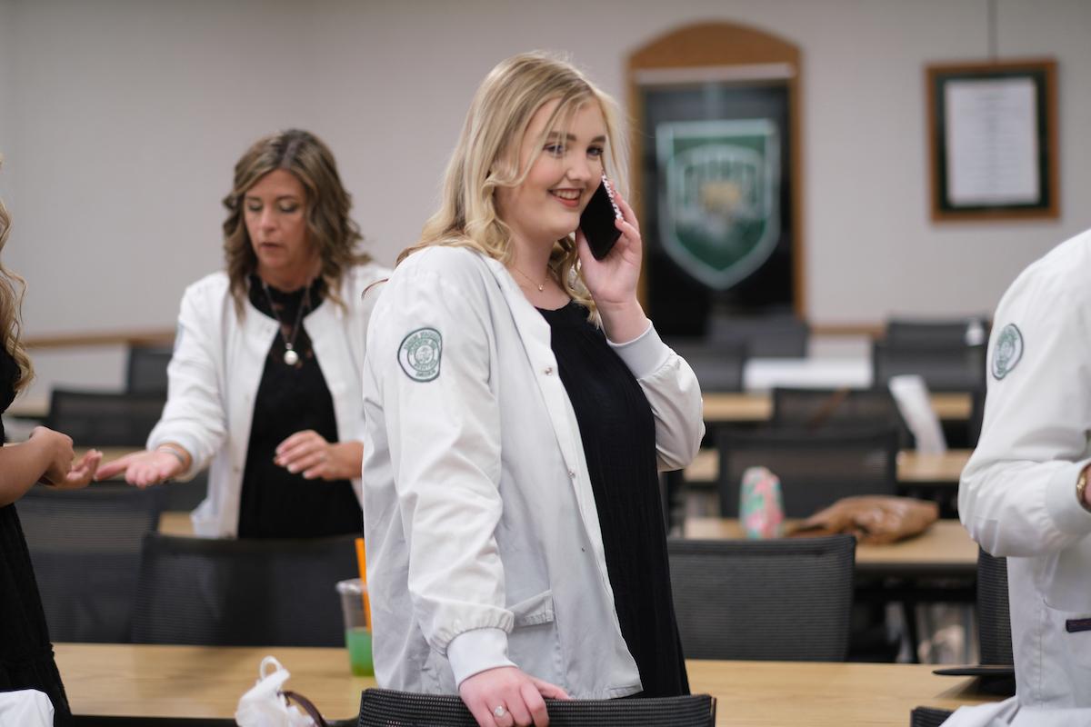 Nursing grad talking on phone in caucus room