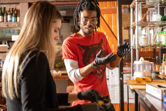 Two people working on brewing.